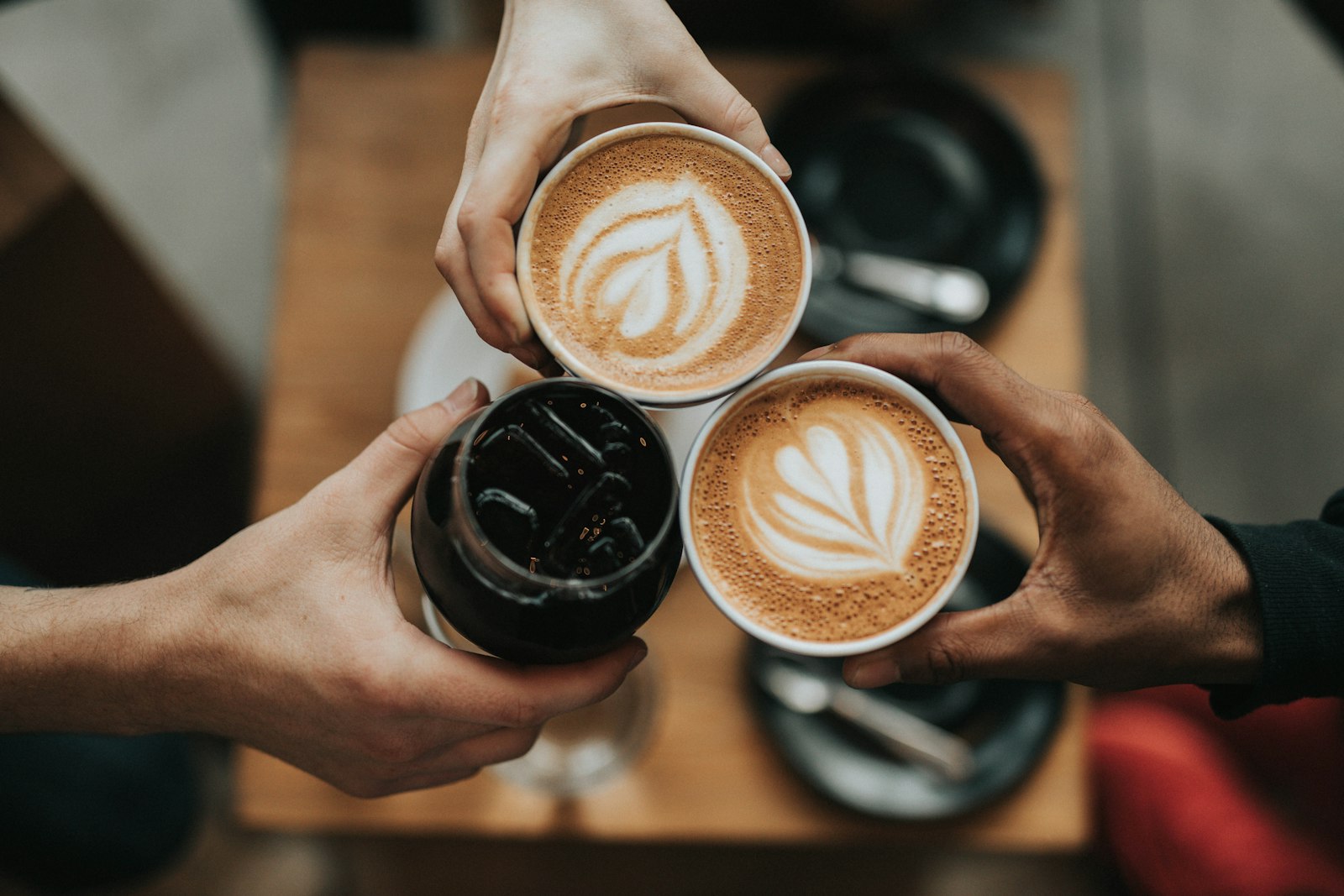 Barista pouring a latte in a sunlit cafe